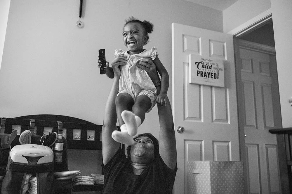 Susie Troxler, 52, plays with daughter Lily, who’s almost two years old, in Lily’s bedroom. “The baby doesn’t know that you’re 50, nor does the baby care,” Troxler says. “You’re gonna have to chase them just as if you’re 25.”