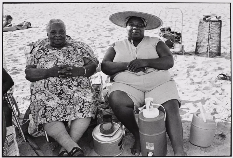 Black-and-white photograph of two women at the beach