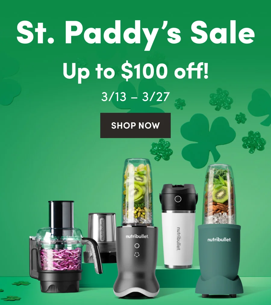 A collection of nutribullet models and attachments, including portable blenders and a food processor, on a green festive backdrop with shamrocks.