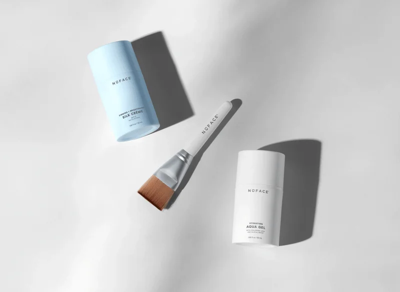 NuFACE microcurrent activators and clean sweep brush against white background.