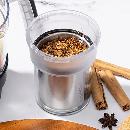 a nutribullet grinder prepped with chinese 5-spice mix and star anise, highlighting its earthy and savory flavor