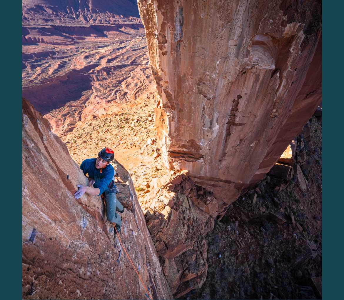Photo of a climber on a desert rock tower.