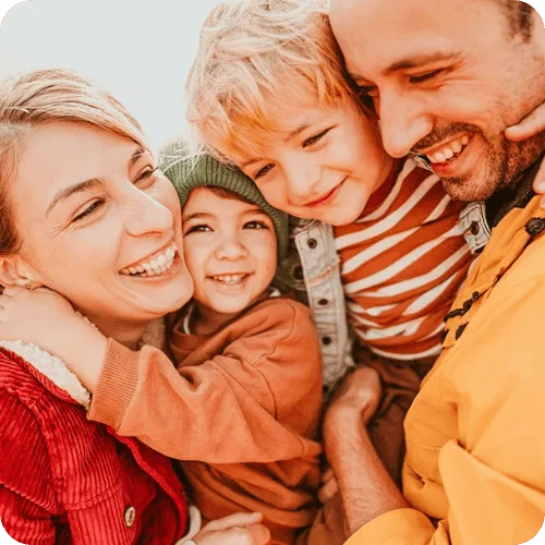 a family hugging and smiling a family hugging and smiling