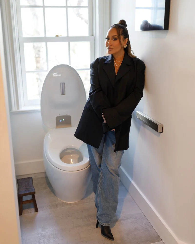 Adrienne Bailon posing in front of her TOTO NEOREST smart toilet