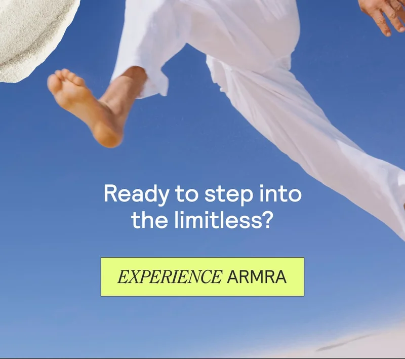 Person in white jumping against blue sky with text: “Ready to step into the limitless?” and button “Experience ARMRA.”