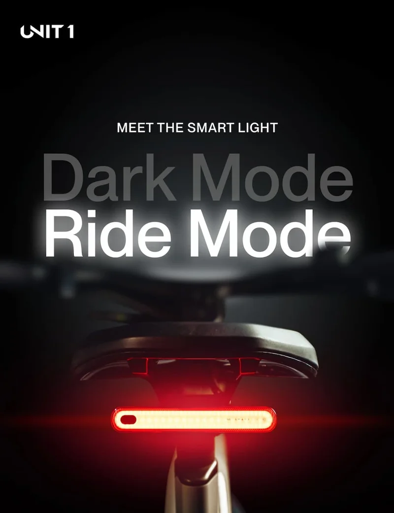 UNIT 1 Smart Light mounted under a bike saddle, showing red rear light with Dark Mode and Ride Mode features.
