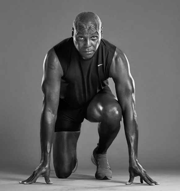 A black-and-white photograph of Carl Lewis