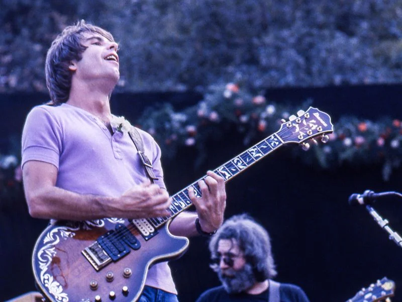 Image may contain: Jerry Garcia, Guitar, Musical Instrument, Adult, Person, Guitarist, Leisure Activities, and Music