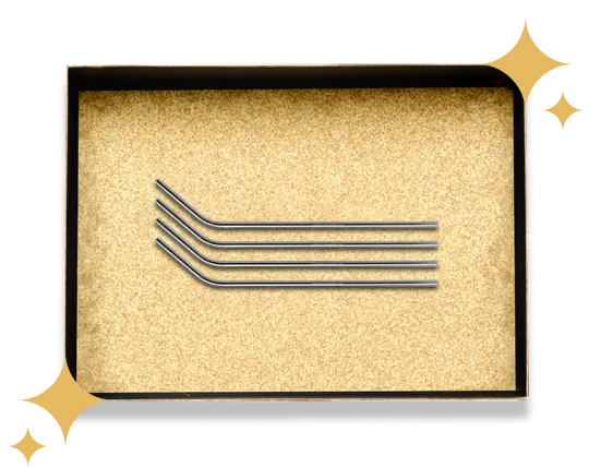 Four stainless steel bent straws arranged parallelly on a golden gift box.