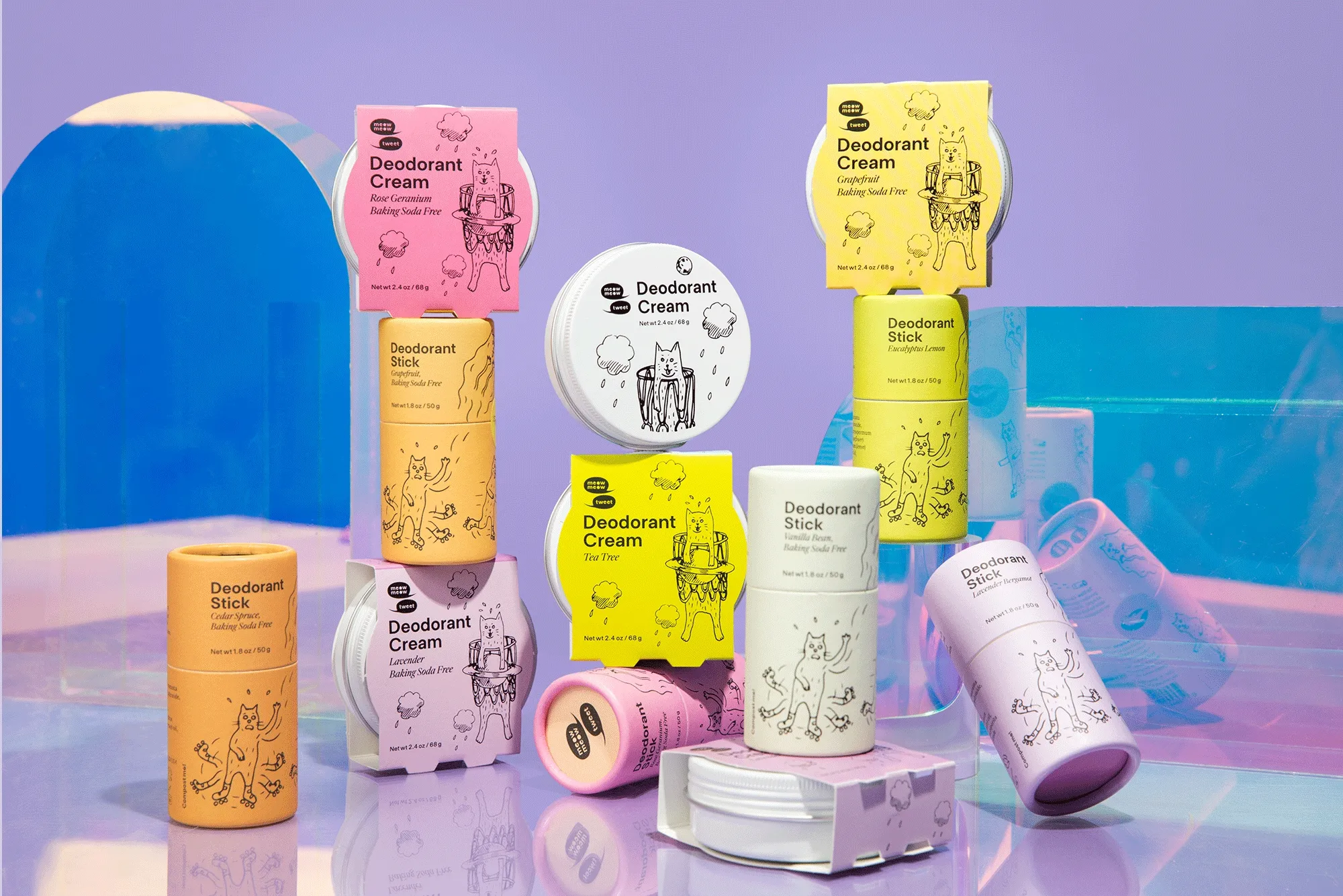 A group of deodorant in colorful tubes and tins are arranged against a reflective purple backdrop, two tins of deodorant rotate side to side.