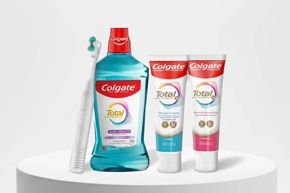 A toothbrush, mouthwash, and two toothpastes from the Colgate Total Active Prevention System.