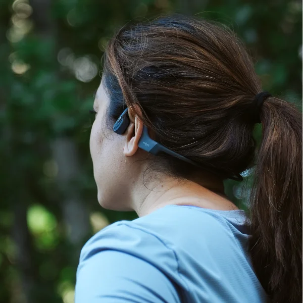 Woman wearing Shokz headphones