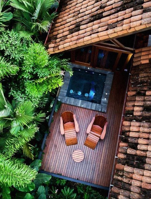 Image Description: Overhead shot of two sun loungers and a private Jacuzzi at a cabin in Hotel Amor Arenal, Costa Rica