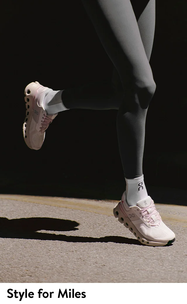 A woman wearing light pink running shoes from On.