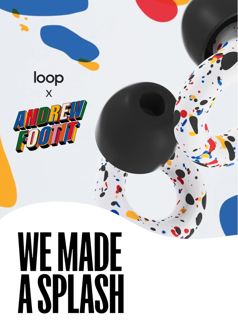 Close-up of the colorful new Experience earplugs from the Loop x Andrew Footit collection, featuring splashes of red, blue, yellow, orange and black atop a white base.