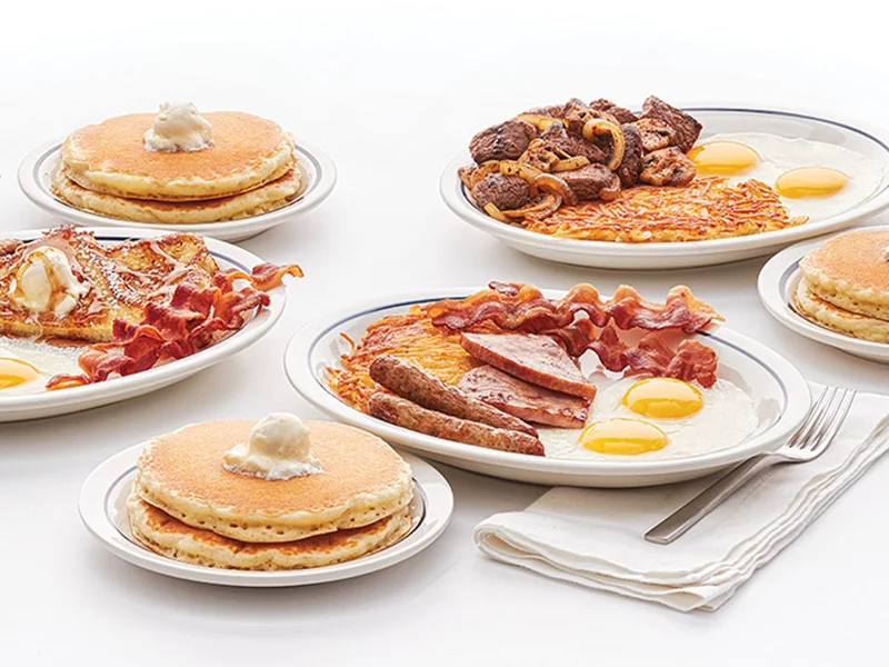Images of IHOP Breakfast Combos, including the Breakfast Sampler with eggs, bacon, ham, and hash browns, and Sirloin Tips with hash browns and eggs, with sides of pancakes.