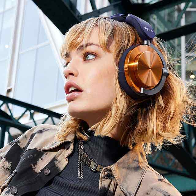 A model lying down while wearing Dyson OnTrac™ headphones.