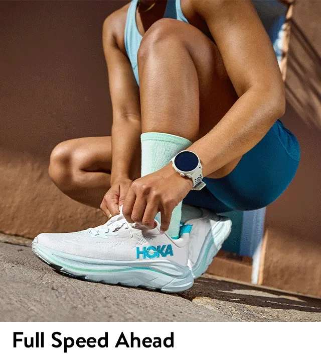 A woman lacing up sneakers. A group of people running down the street.