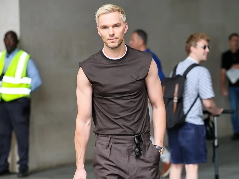 Image may contain: Nicholas Hoult, Pedestrian, Person, Adult, Child, Accessories, Bag, Handbag, Clothing, Pants, and Backpack