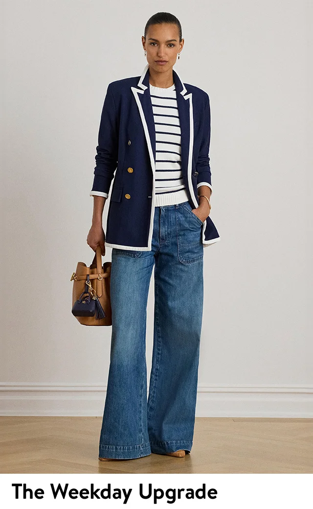 A woman wearing a striped shirt with a blazer and jeans.