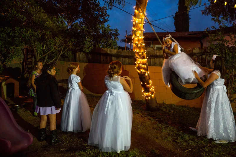 Girls play outside after their first communion mass in La Puente, California.