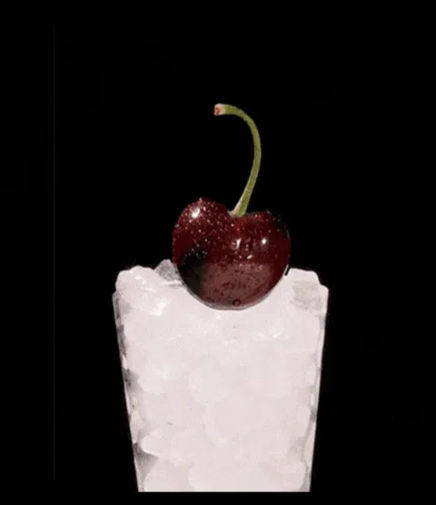 gif of pouring black cherry wynk into a cup with ice and a cherry garnish