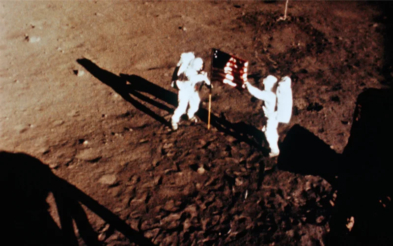 Neil A. Armstrong (left) and Edwin 'Buzz' Aldrin, Jr., raise the American flag on the moon in 1969.