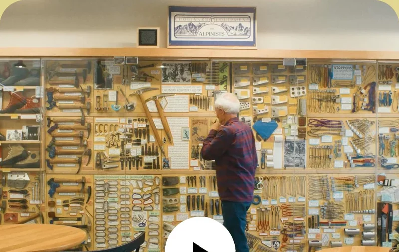 A person looking at old climbing equipment.