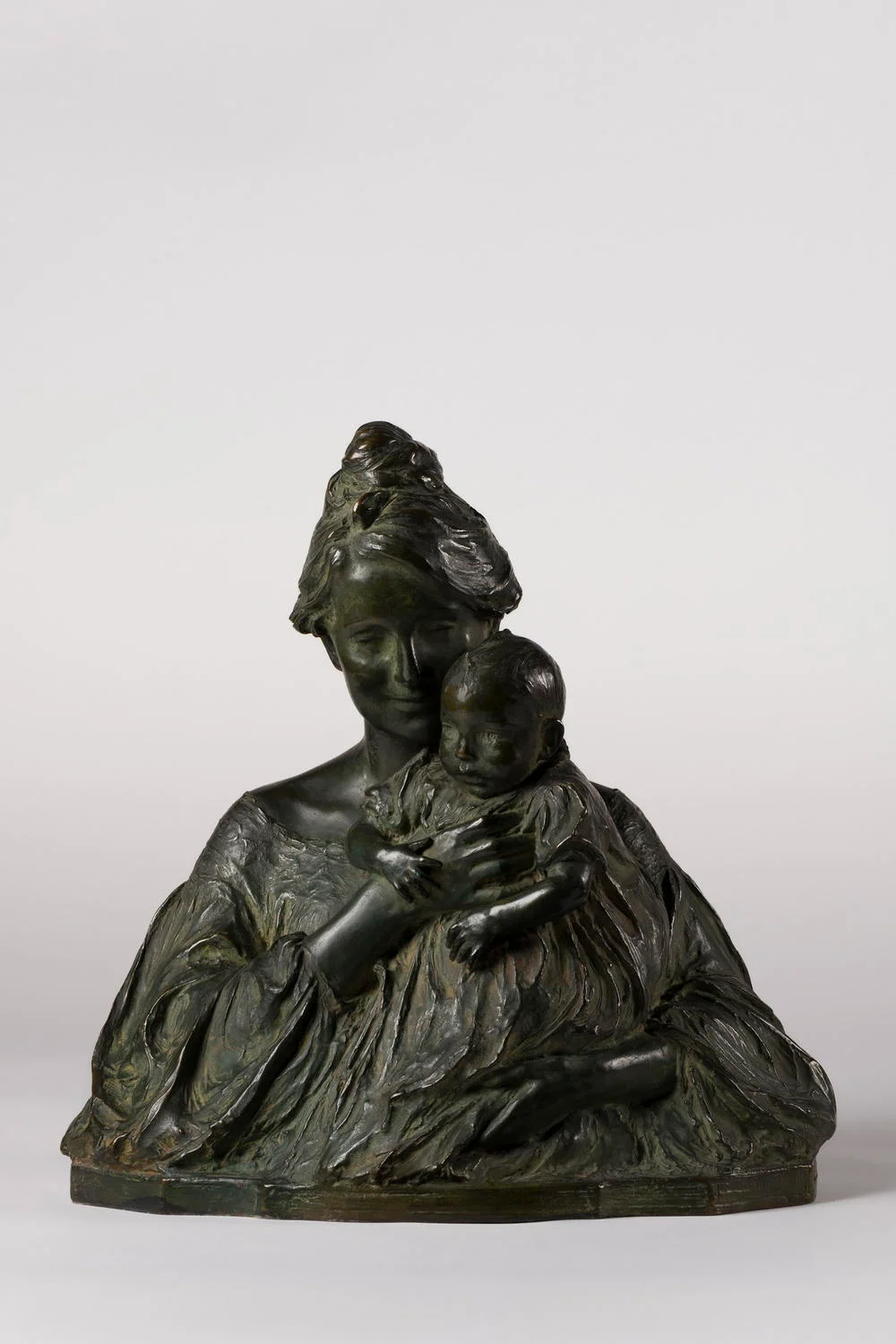 Bronze sculpture of a woman holding a baby
