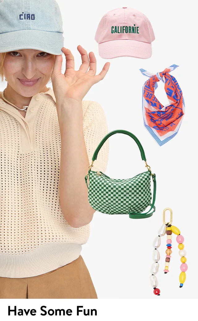 A woman wearing a baseball cap that says Ciao. An orange and blue scarf, green and white bag and beaded bag charm.