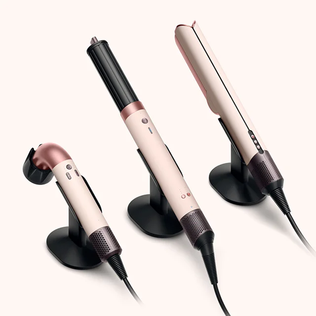 Three Dyson hair care machines placed on hair tool stands