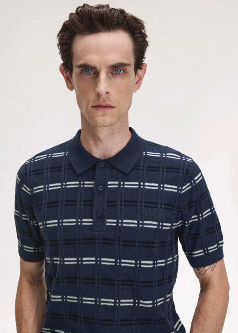 Fred Perry New Releases: model wears a Fred Perry Striped Rib Knitted Shirt in Tennis Blue
