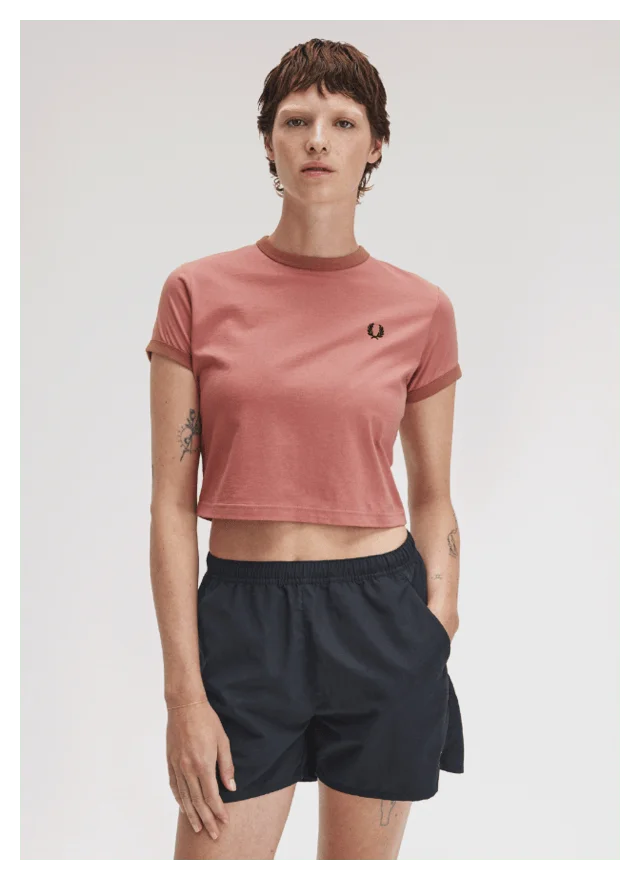 Fred Perry New Releases: Women model wears a Fred Perry Cropped Ringer T-Shirt in Putty Pink