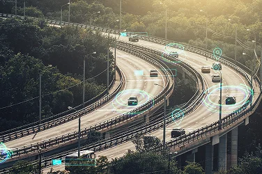 A busy highway overpass with electronic graphics surrounding each vehicle to illustrate intelligent driving technology.