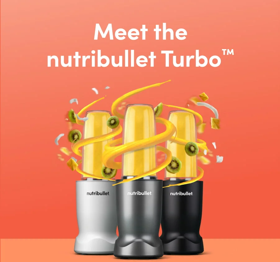 Three nutribullet blenders in white, silver, and black are displayed against a vibrant orange background. Each blender contains a bright yellow smoothie, with swirling ribbons of smoothie, kiwi slices, pineapple chunks, and coconut flakes flying around them, creating an energetic and tropical vibe.