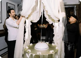 Drapery over cake with people