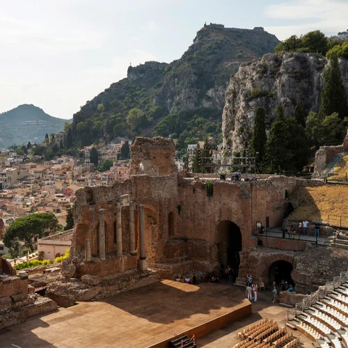 The Ancient Theatre of Taormina, the second largest theater in Sicily, hosts concerts and plays amongst centuries-old ruins. The semi-circular theater provides a great vantage point for views of two bays and Mount Etna.