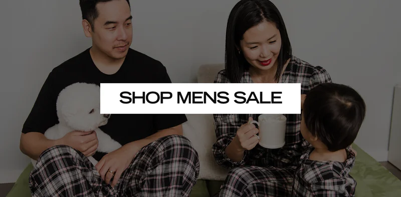 family wearing plaid pyjamas with text SHOP MENS SALE