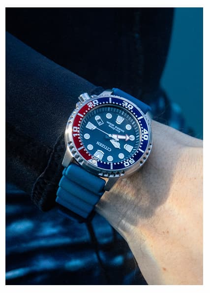 Person in diving gear wearing a blue strap Promaster Div