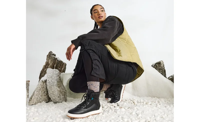 Picture of a female model wearing the brand new Alta High Top.