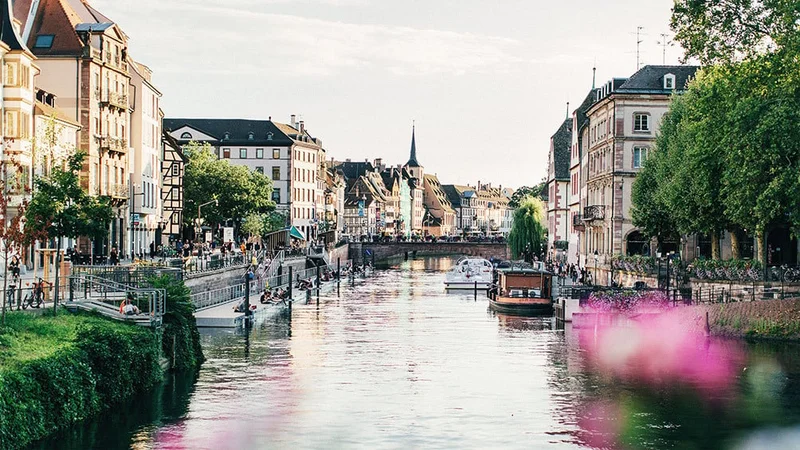 Image description: Boats on canal in Strasbourg, France, in springtime