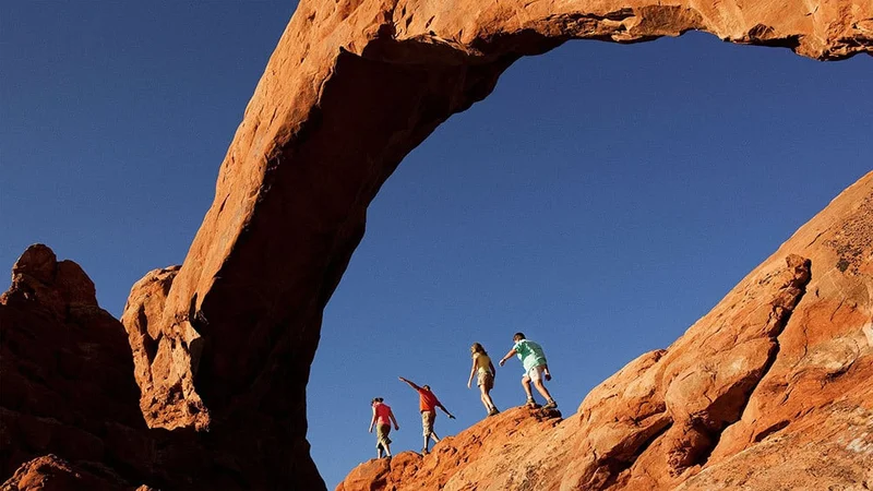 Image description: Family of four hiking in Arches National Park, Utah
