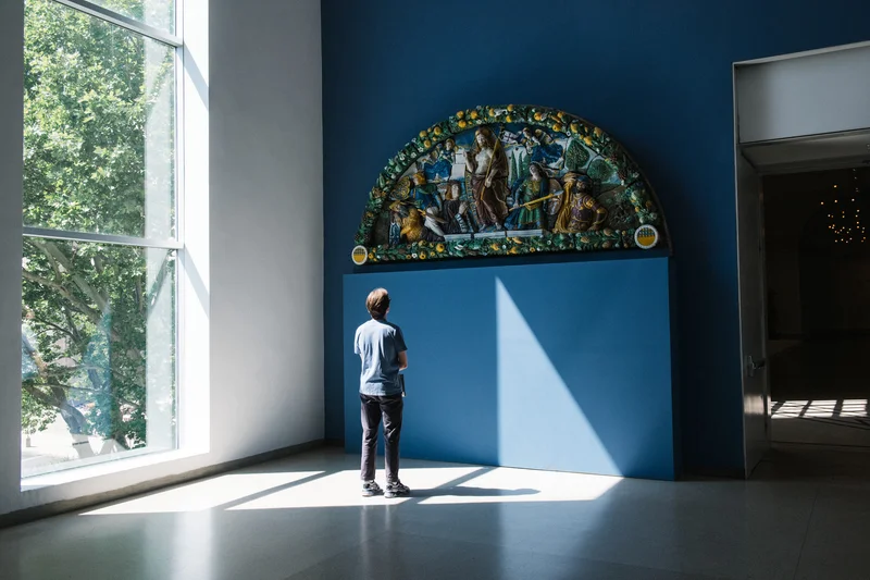 A photograph of a person looking at art