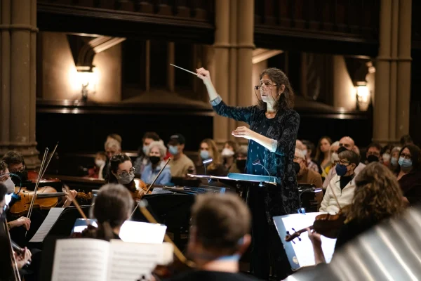 A conductor leading an orchestra