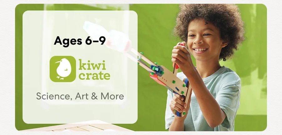 Young child smiling while working on a science experiment from KiwiCo Labs. Hands-on STEM learning for ages 6–9