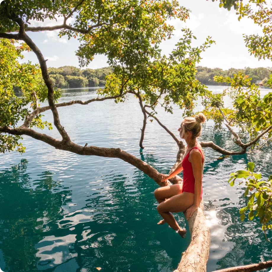 Woman sitting on a tree branch, Mexico