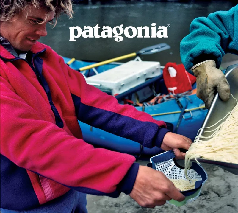 Patagonia. A person on the bank of a river uses their mesh hat as a spaghetti strainer.