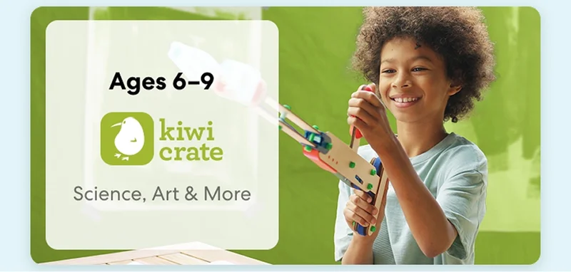 Young child smiling while working on a science experiment from KiwiCo Labs. Hands-on STEM learning for ages 6–9