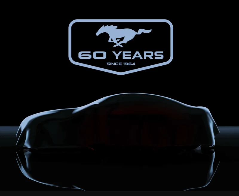 Badge reading 60 years since 1964 above a silhouette of a vehicle covered by a tarpaulin