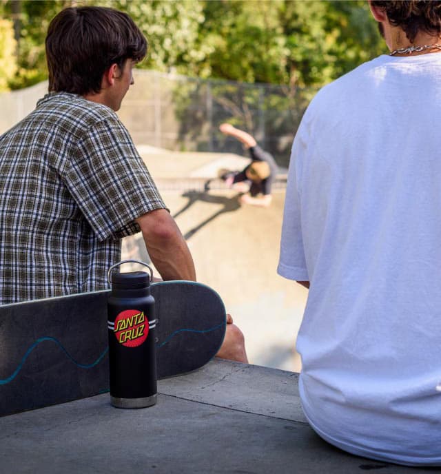 Two skateboarders with water bottle.